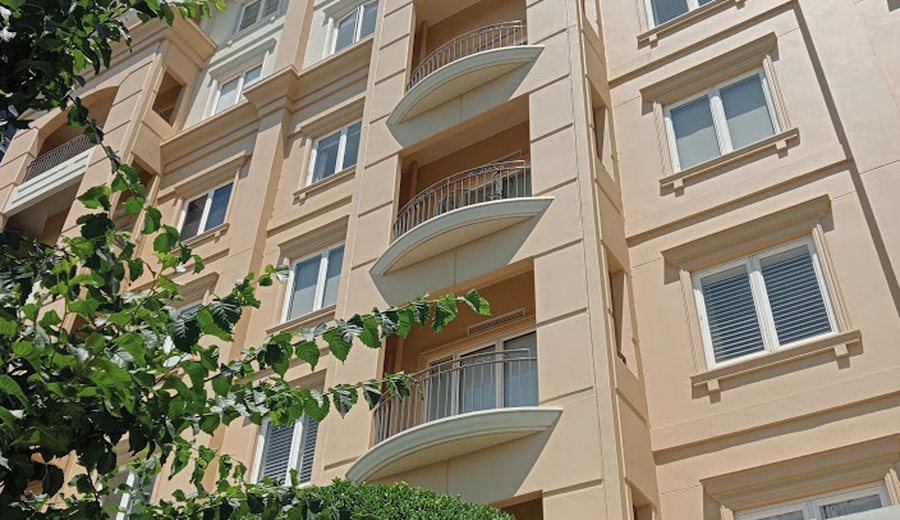 Residential apartment building with balconies and landscaping