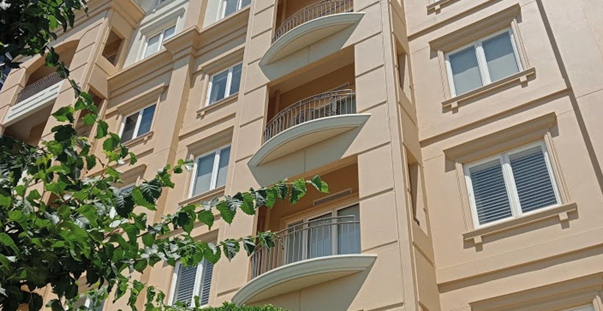 High-rise residential tower facade with glass and podium levels